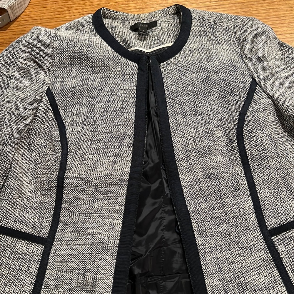 J Crew teed suit with navy piping detail. High-waisted skirt.